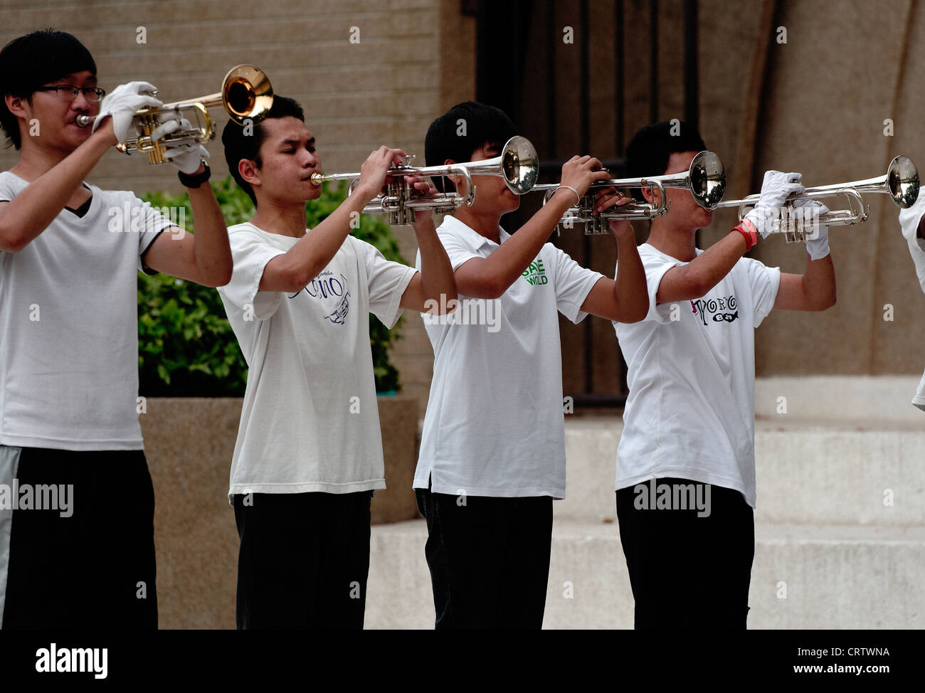 Group of young Thai boys and girls playing in a brass band in Lumpini