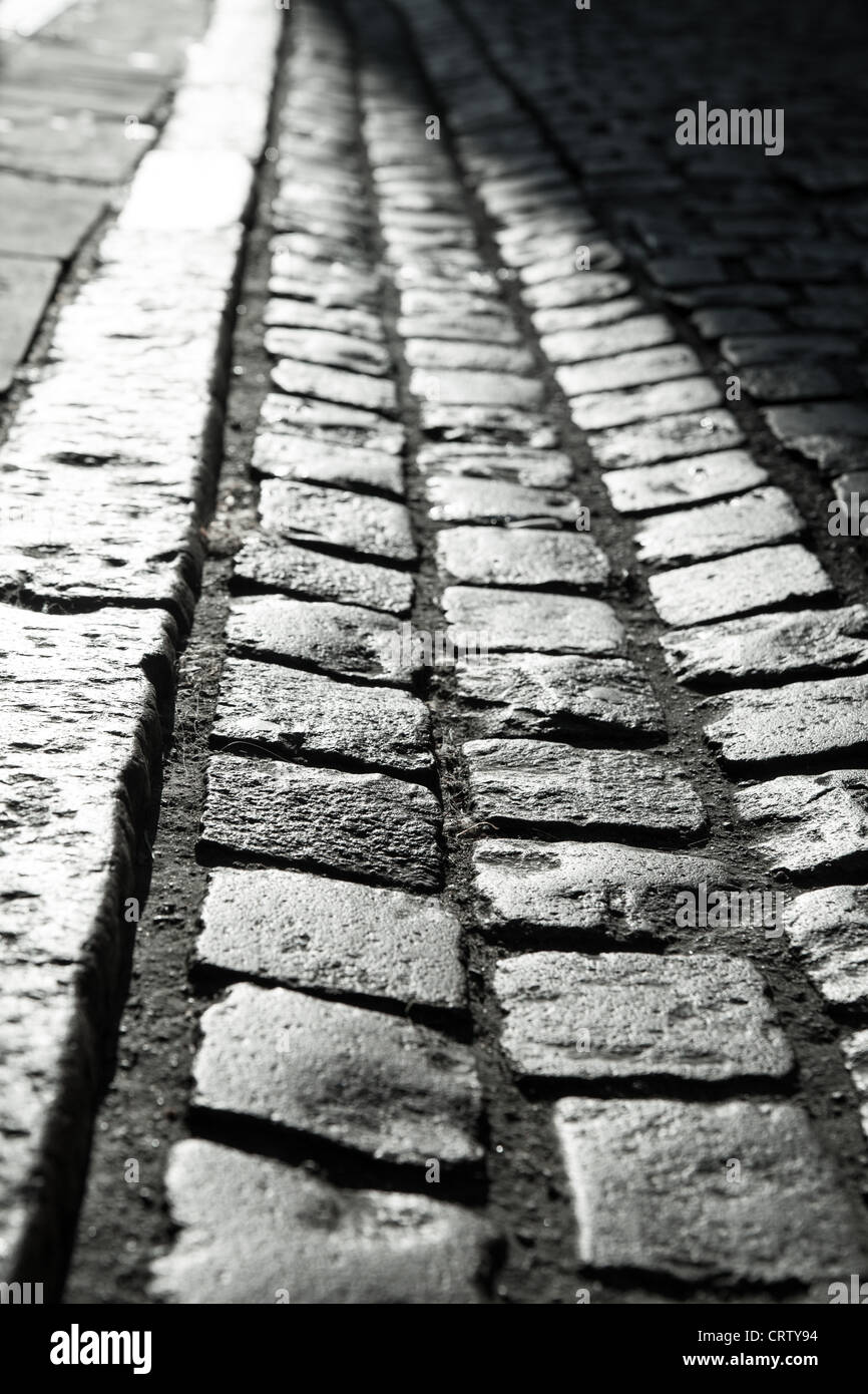 Green Street, Cobbled street in Cambridge early morning casting long shadows over the cobbles. Stock Photo