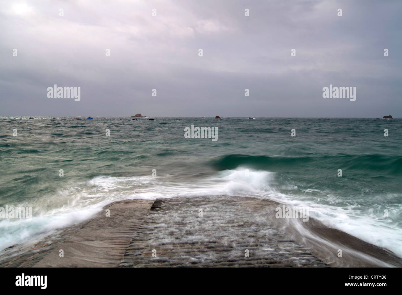 Cobo slip Guernsey, Waves crashing on slipway Stock Photo