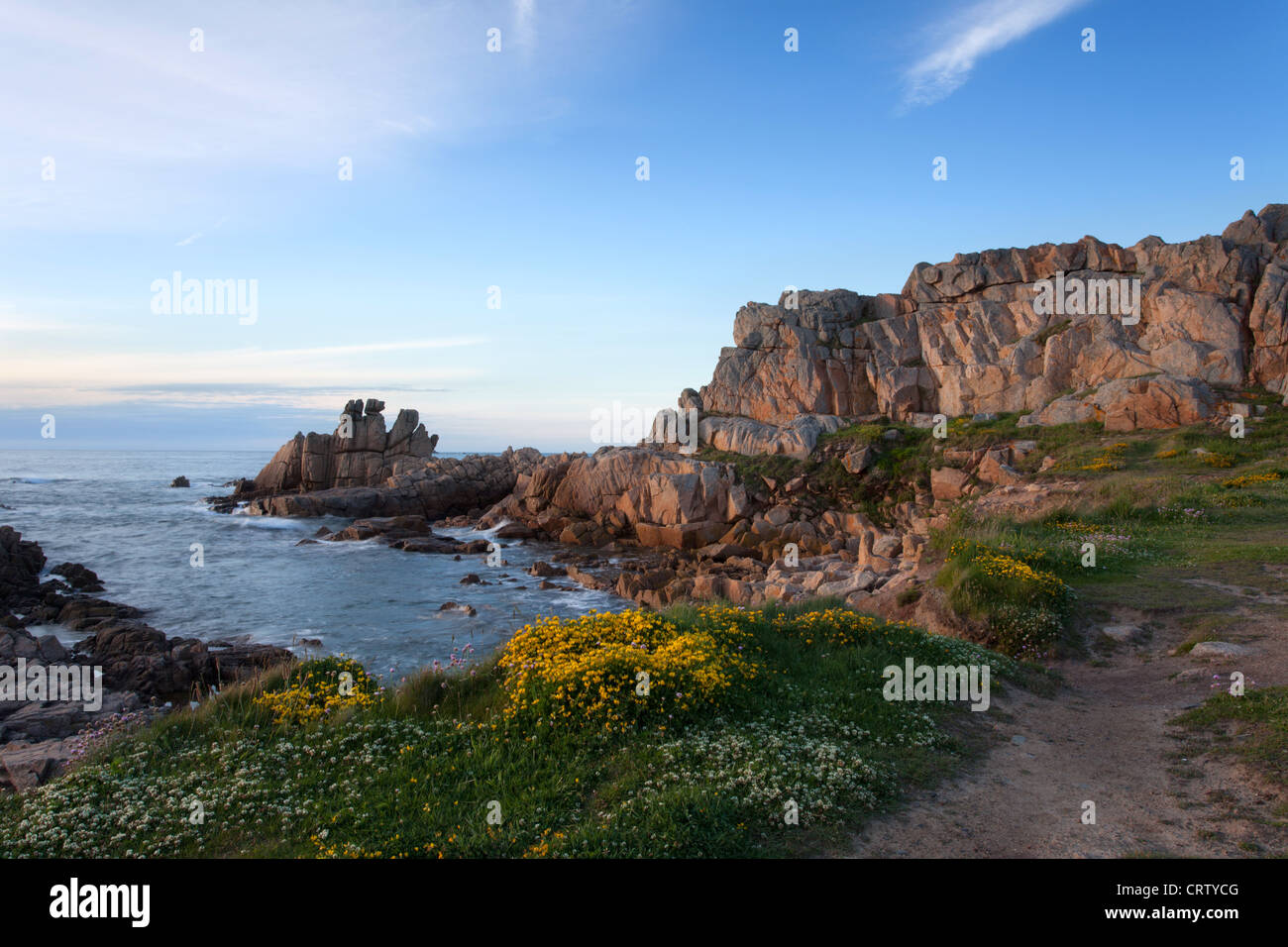 Grandes Rocques pathway and rock outcrop in the warm evening sun, Guernsey, Channel Isles, UK Stock Photo