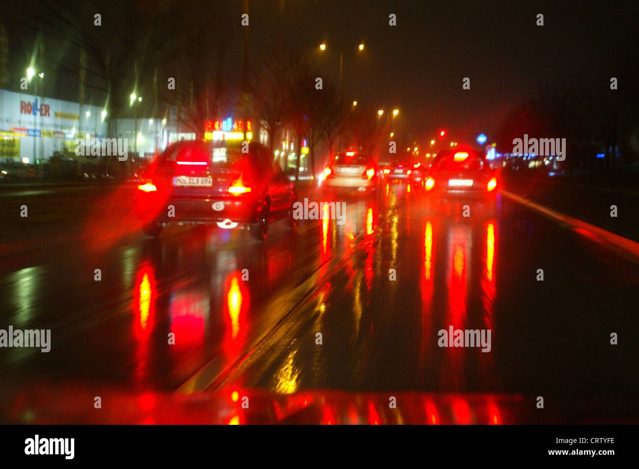 Brake lights of cars on wet road Stock Photo