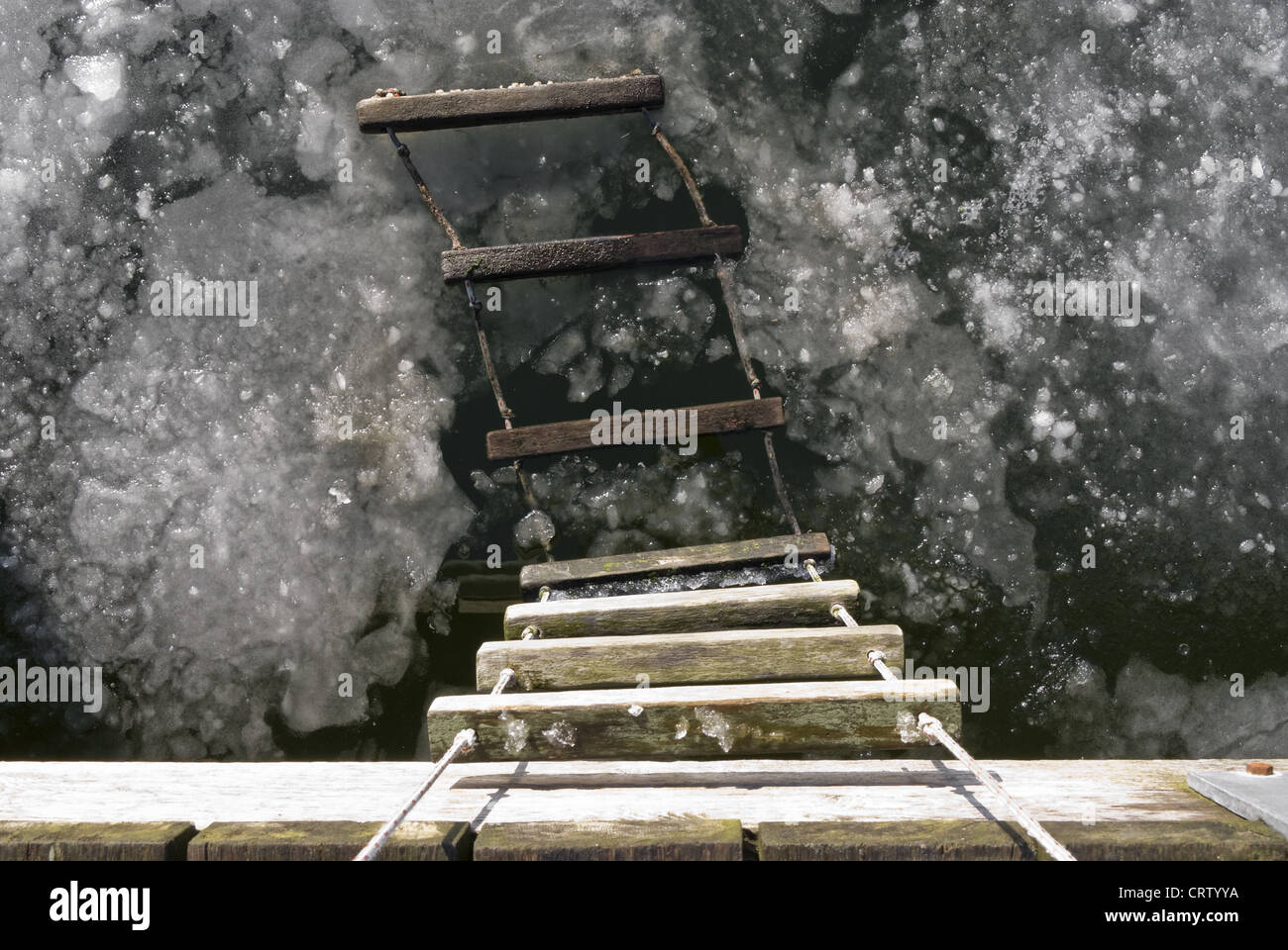 Rope ladder on a jetty in the frozen Schlei Stock Photo