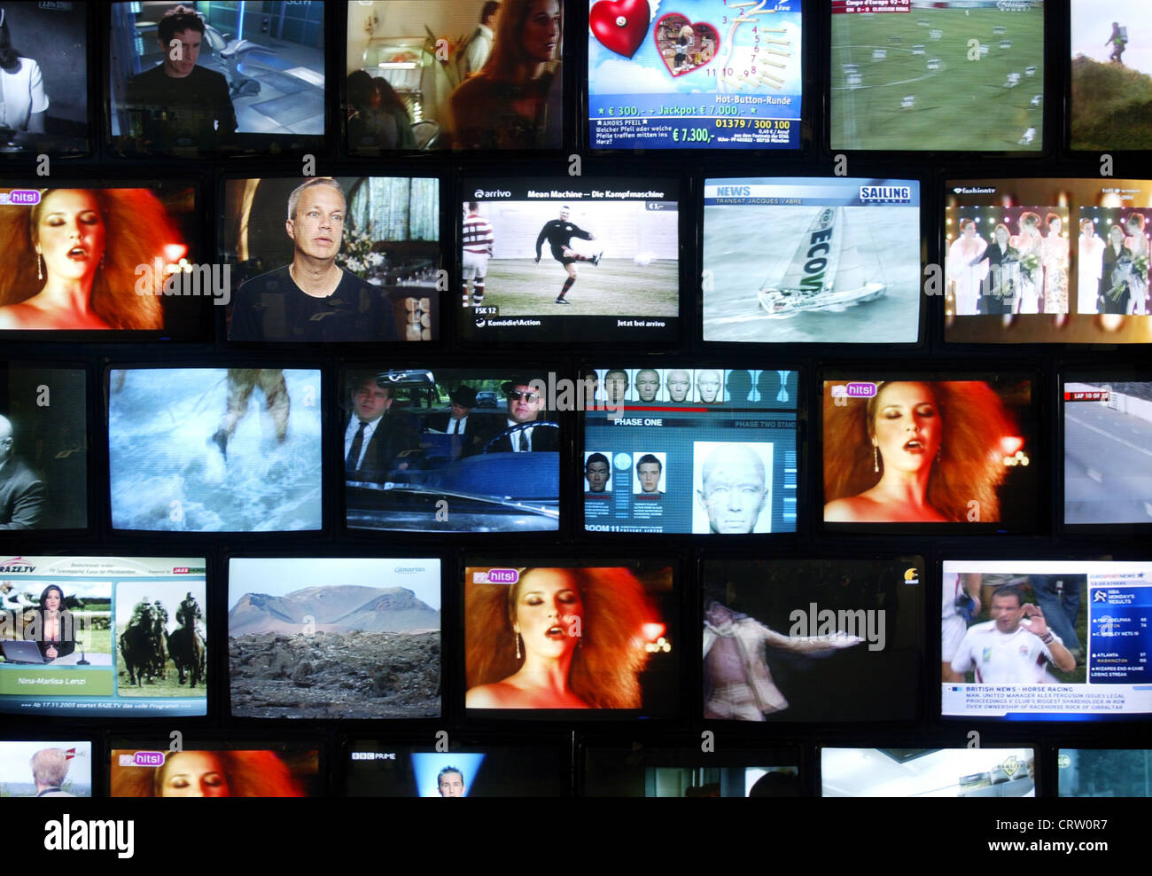 Monitor wall with various TV programs Stock Photo