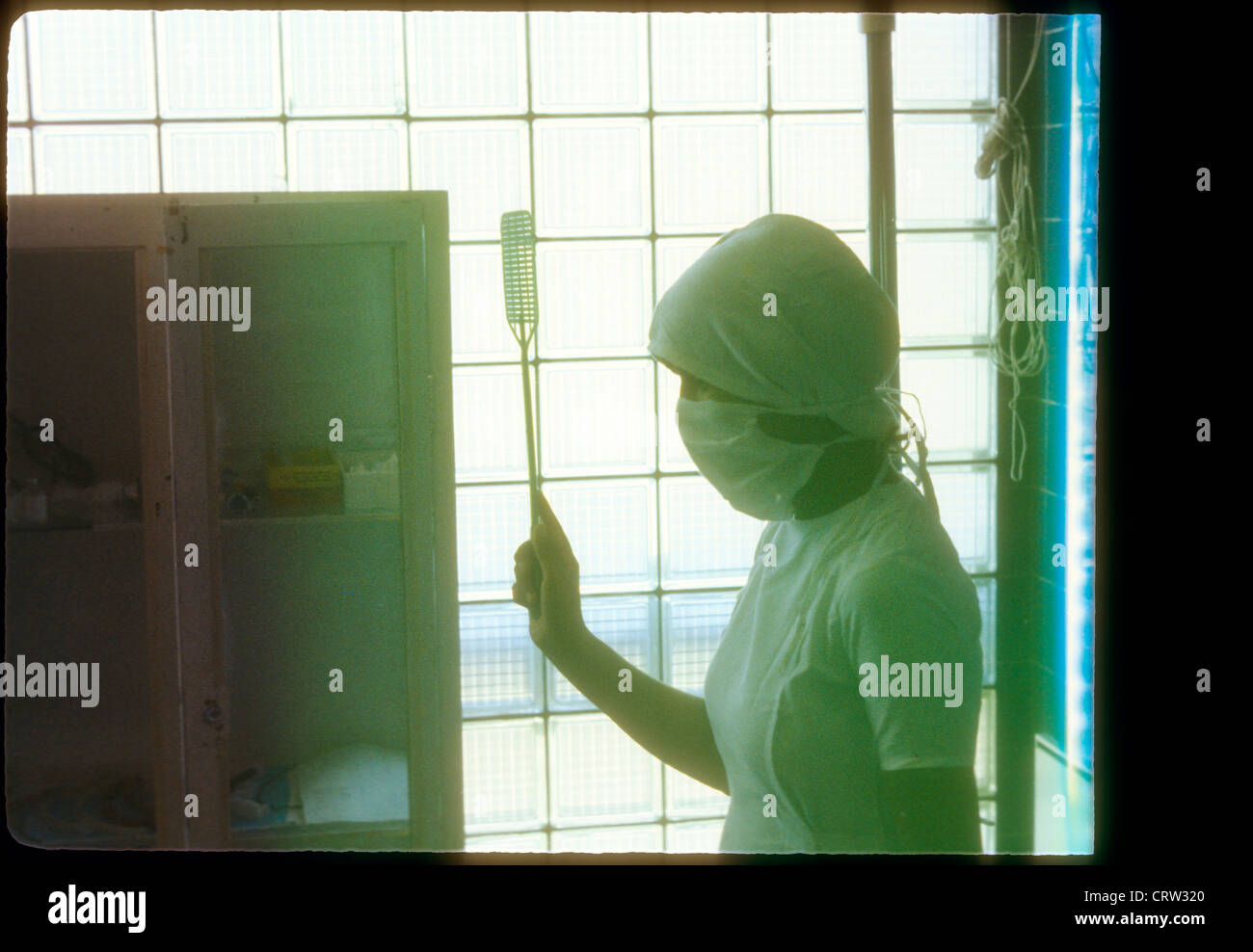 nurse with fly swatter at jamhuriat hospital kabul in afghanistan