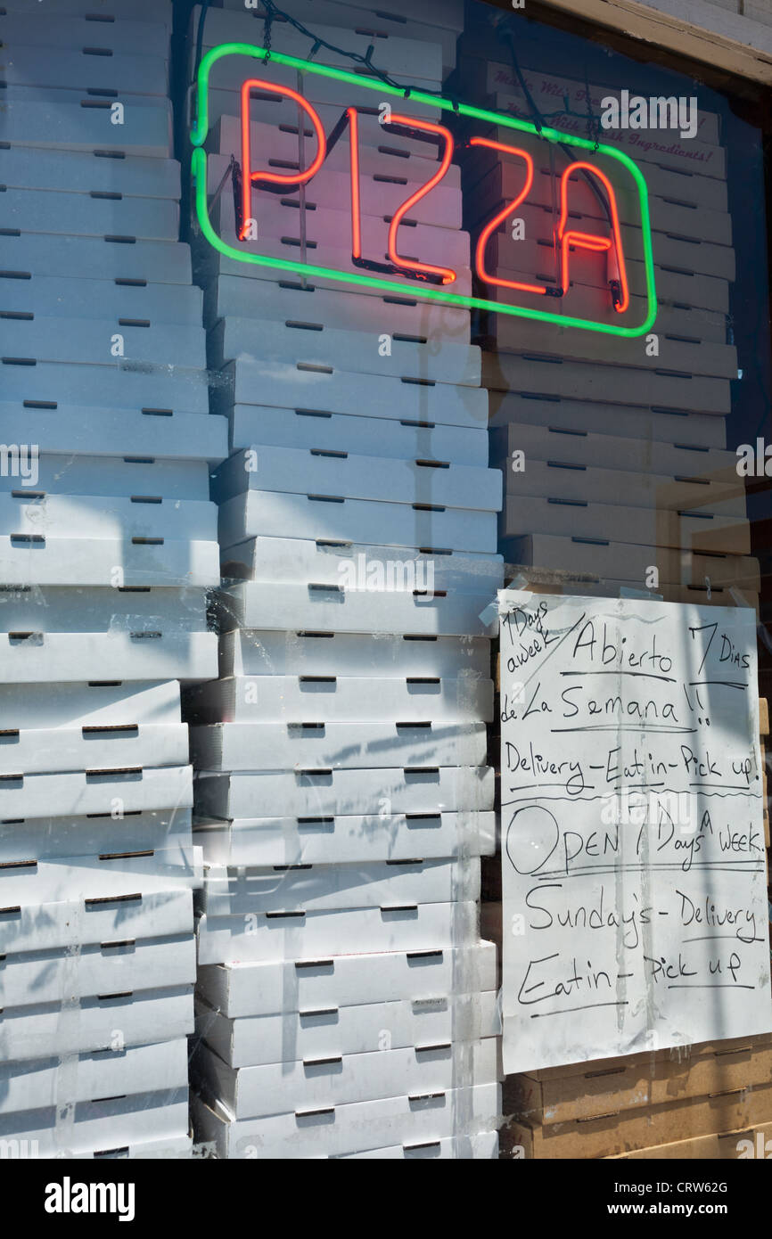 Pizza boxes stacked in window of a restaurant in Reading, Pennsylvania