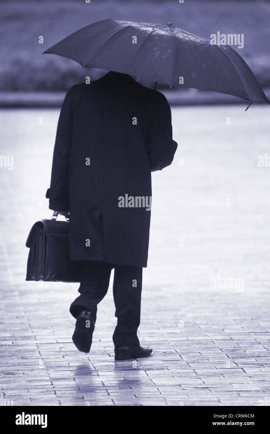 Businessman in the rain Stock Photo - Alamy