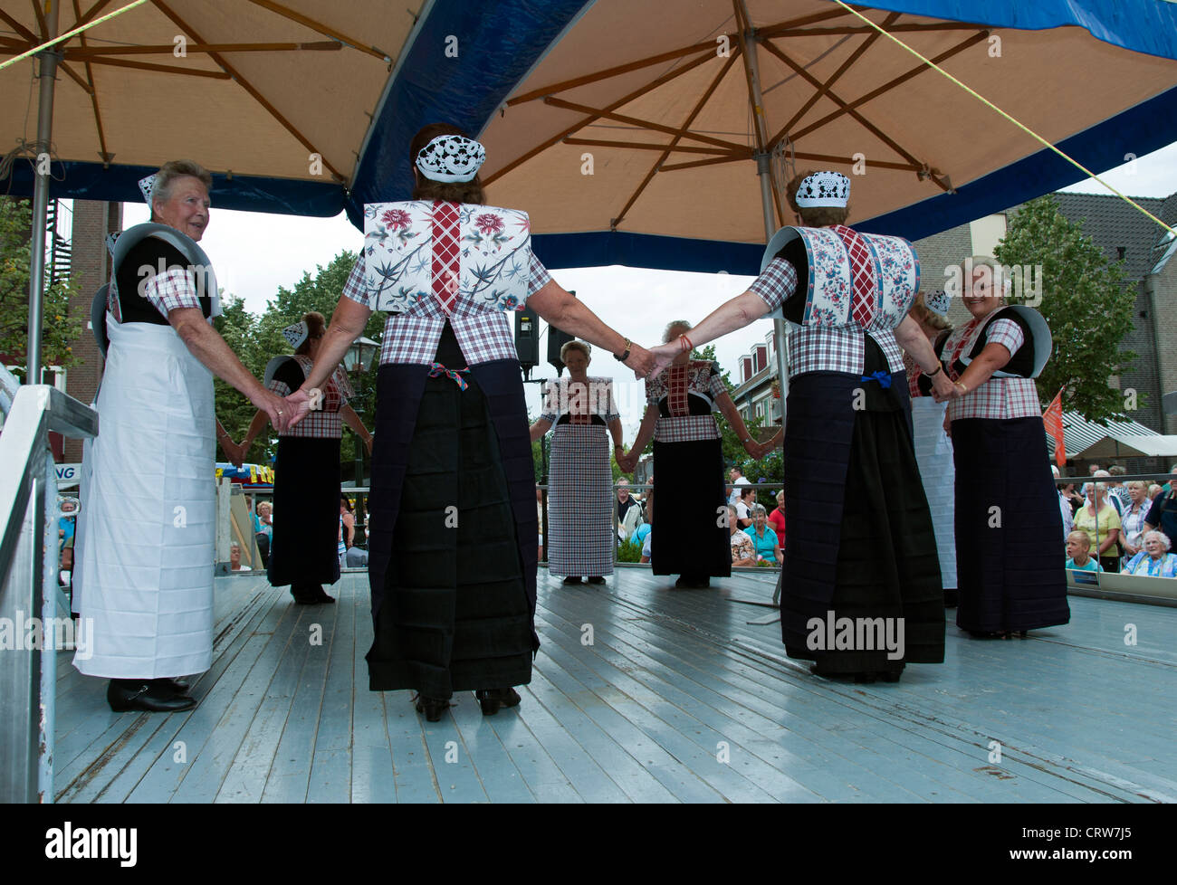 lady in dutch old traditional costumes dancing for tourists Stock Photo