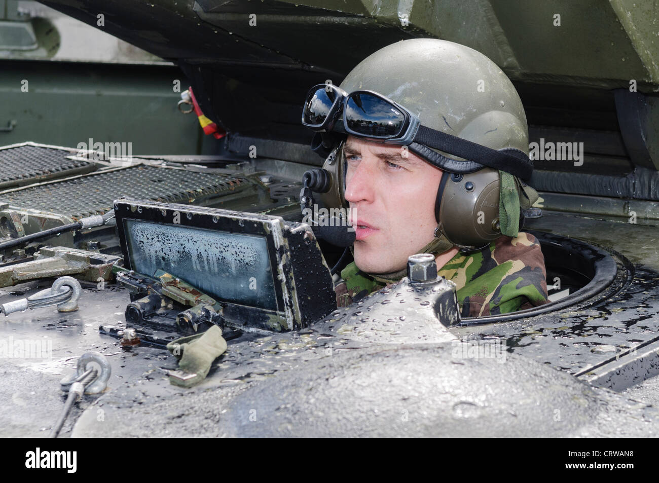 Soldier drives a Scimitar reconnaisance vehicle Stock Photo