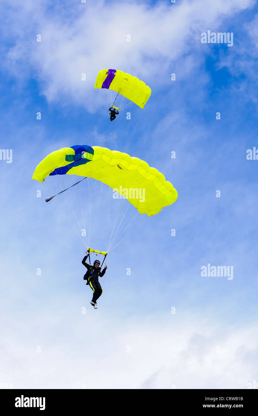 Two parachutists from the Wild Geese display team come in to land Stock Photo