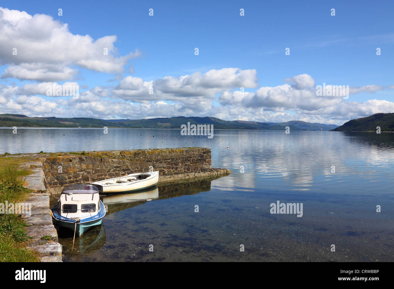 leisure boats moored at the jetty, Otter Ferry, on the shore of Loch Fyne, Argyll, Scotland Stock Photo