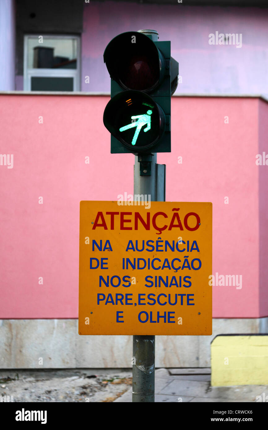 Sign in Portuguese warning people to look and listen for trains if lights not working , Vila Praia de Ancora , Portugal Stock Photo