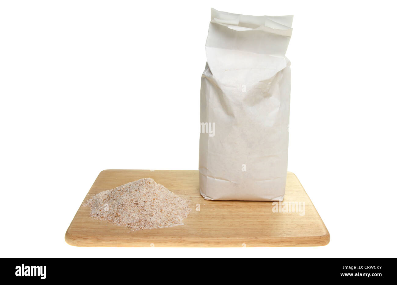 Bag and pile of wholegrain flour on a board isolated against white Stock Photo
