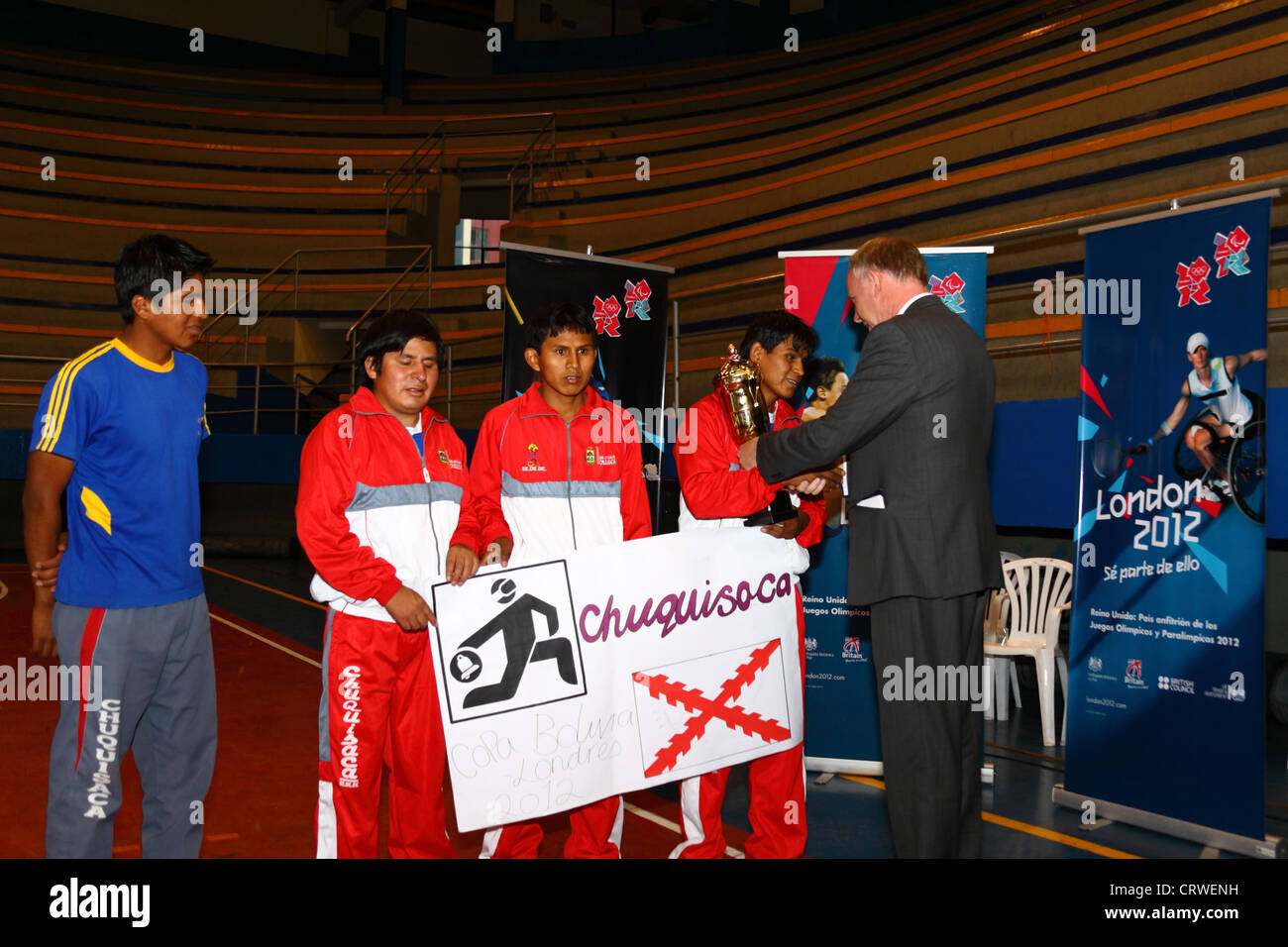British Ambassador Ross Denny presents the winners trophy to the Chuquisaca / Sucre team at a goalball tournament , Bolivia. Stock Photo
