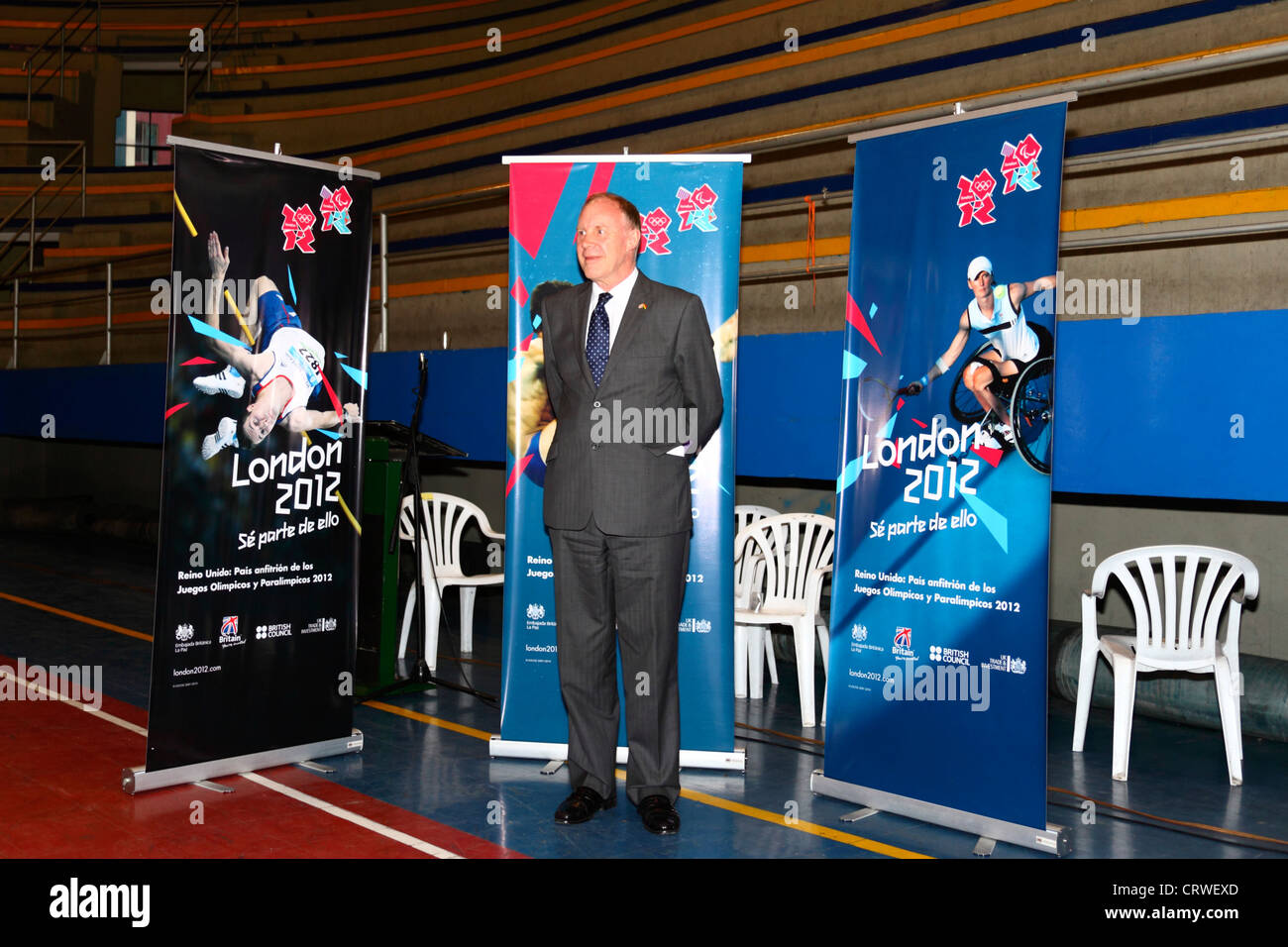 British Ambassador Ross Denny poses in front of London 2012 Paralympic Games banners at a goalball tournament , Bolivia. Stock Photo
