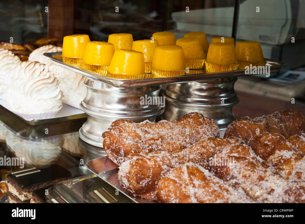 Traditional cakes for sale in a bakery window in the town of Figueres