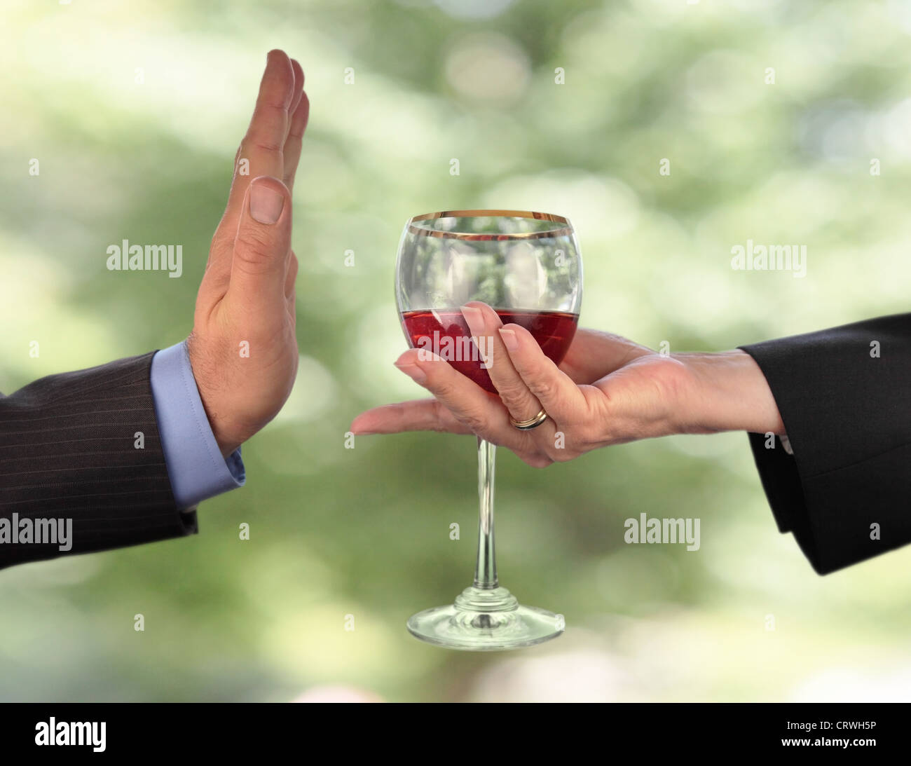 someone is being offered a drink which he is refusing Stock Photo