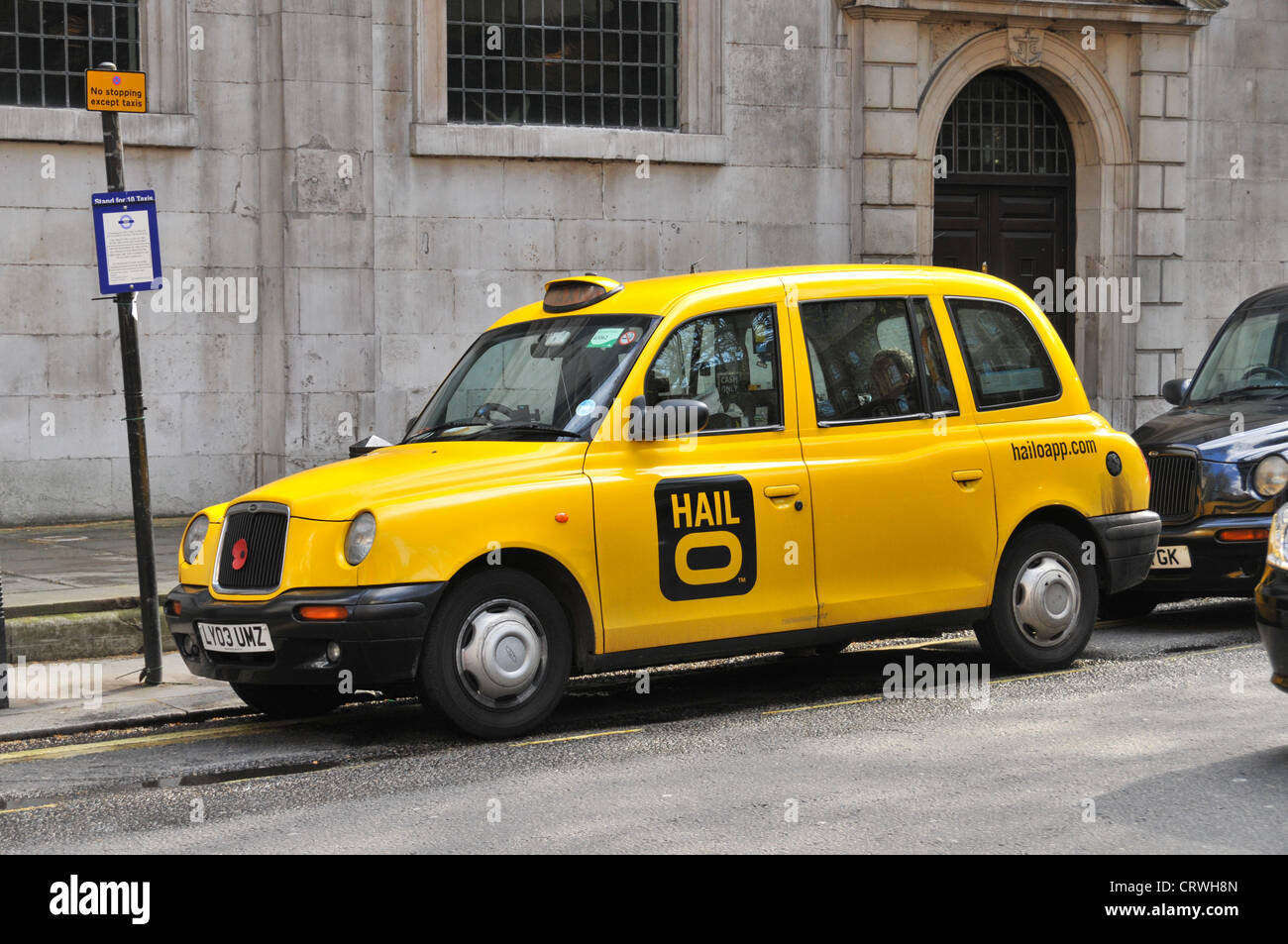 Black cab London Hailo app Hail o yellow taxi Stock Photo