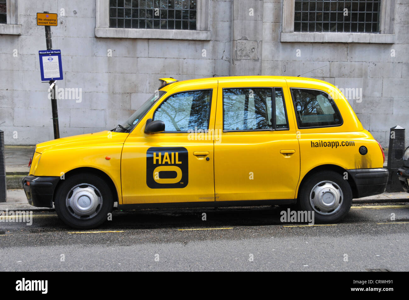 Black cab London Hailo app Hail o yellow taxi Stock Photo