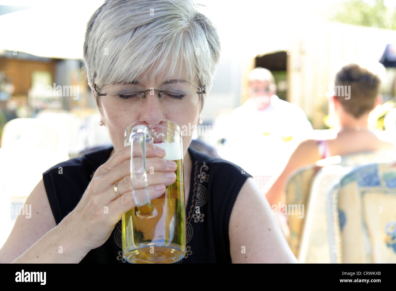 Woman drinking a beer with my eyes closed Stock Photo