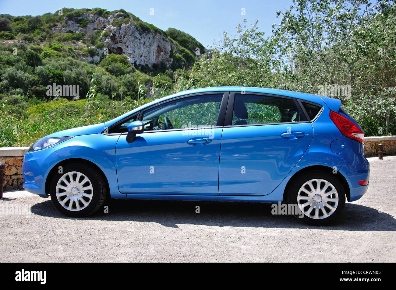 Blue Ford Fiesta saloon car, Cala en Porter, Menorca, Balearic Islands, Spain Stock Photo