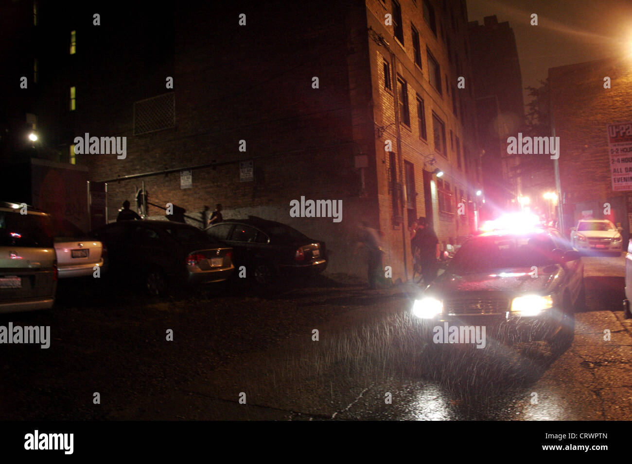 Seattle police car in a back alley in the rain. Stock Photo