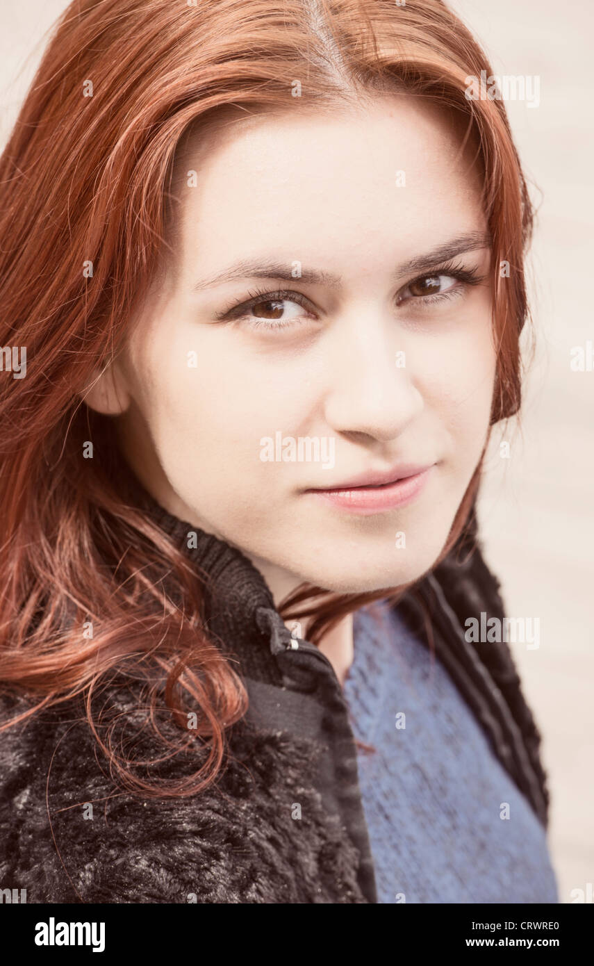 Portrait of a young adult female with red hair looking at camera Stock Photo