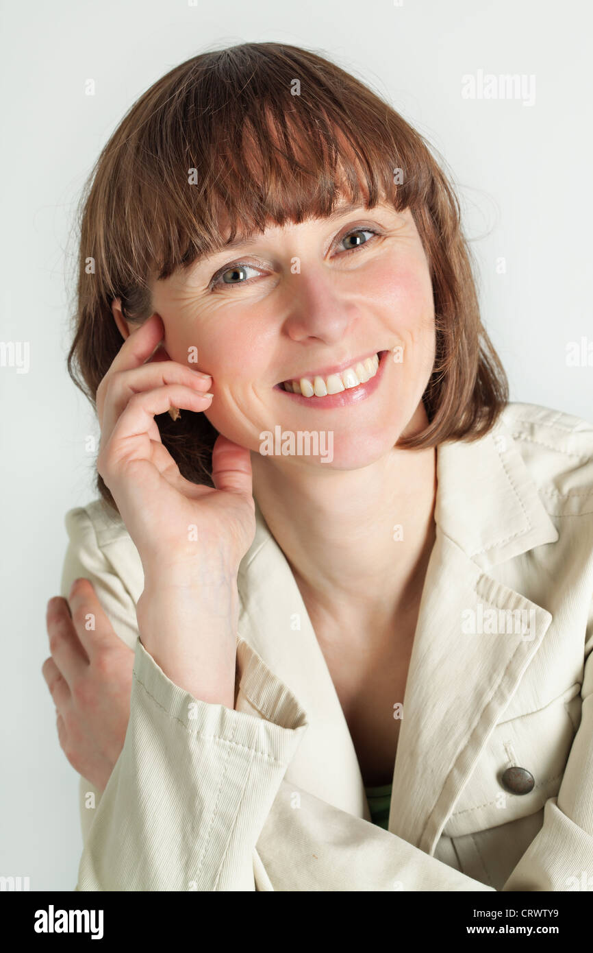 Vertical portrait of smiling middle aged woman Stock Photo