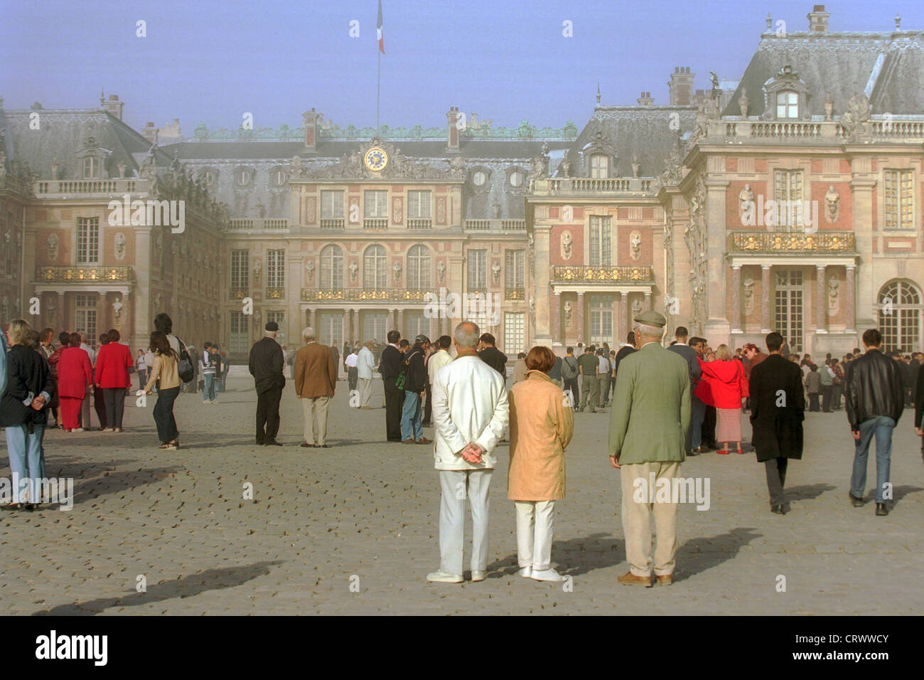 Tourists in front of the backdrop of the castle of Versailles near Paris Stock Photo