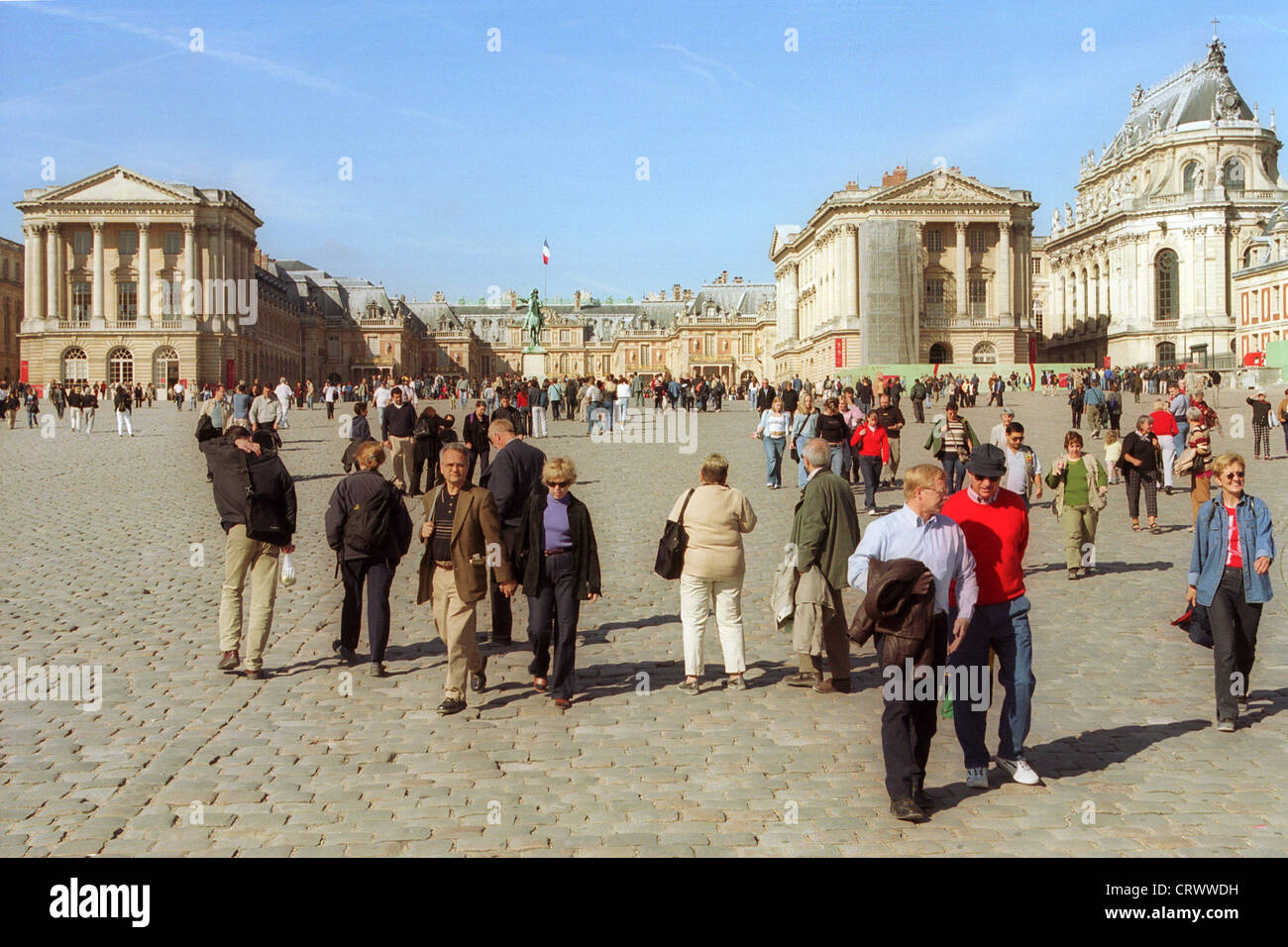 Tourists walk in front of the Palace of Versailles Stock Photo