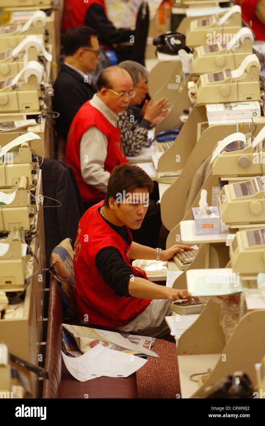 Dealer at work in the Stock Exchange of Hong Kong Stock Photo