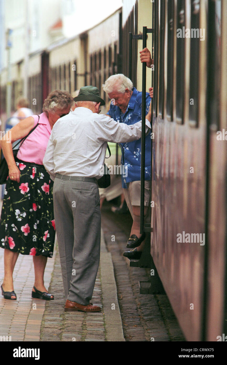 Pensioners help each other when getting Stock Photo