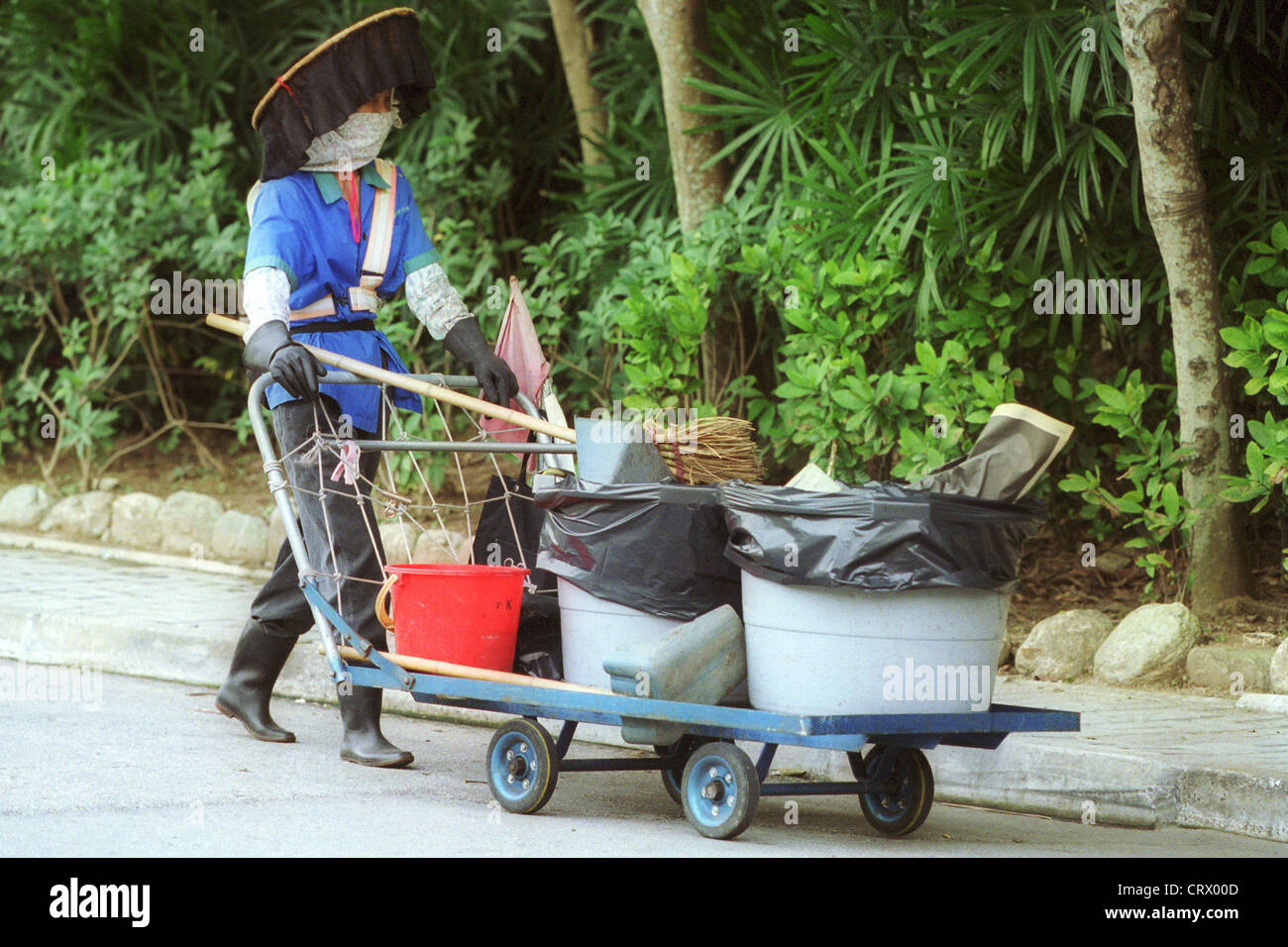 A woman cleaning the streets in Kowloon Stock Photo
