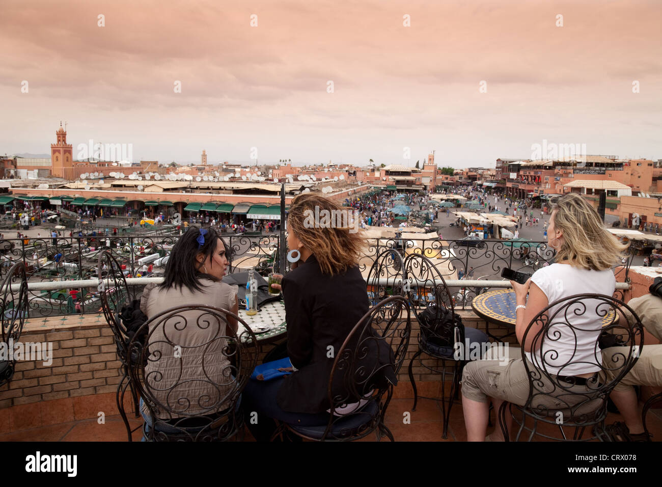Women sitting at  Cafe Glacier in the evening overlooking Djemaa el Fna square Marrakech Marrakesh Morocco Africa Stock Photo