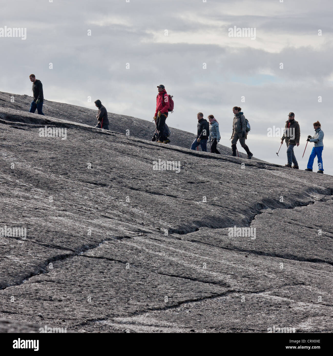 Person Walking On Glacier Ice Surface Wearing Crampons Stock Photo