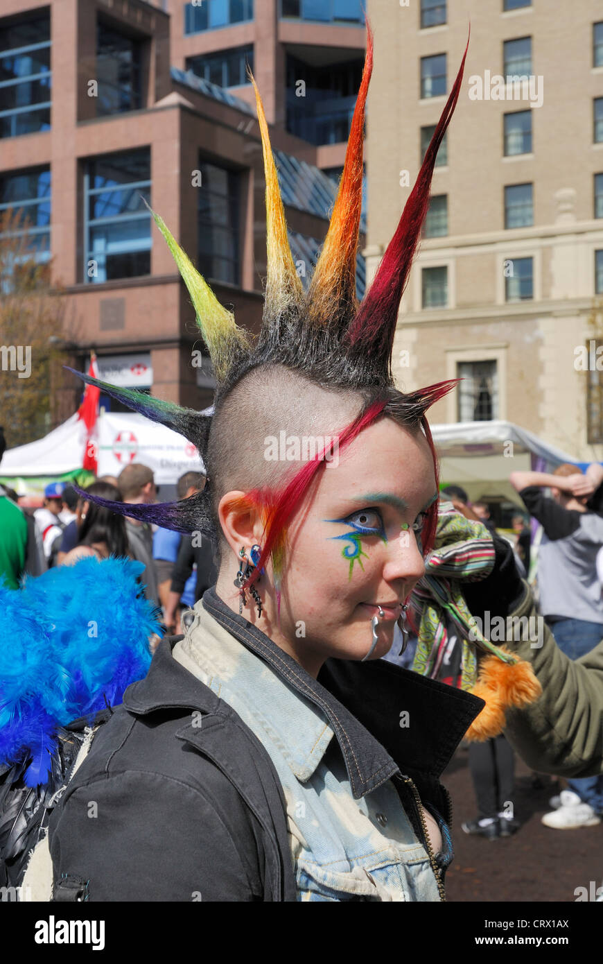Female with the side of her hair shaved and the top colorfully spiked attending the annual 4 20 in Vancouver. Stock Photo