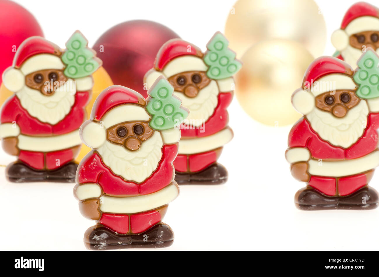Belgian chocolate Father Christmas's on a festive background - shallow depth of field Stock Photo