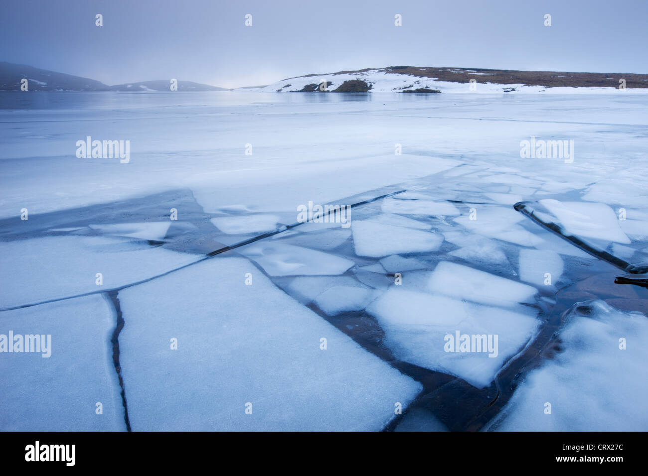 Broken ice on the surface of Llyn y Fan Fawr, surrounded by hill fog, Black Mountain, Brecon Beacons, Wales Stock Photo