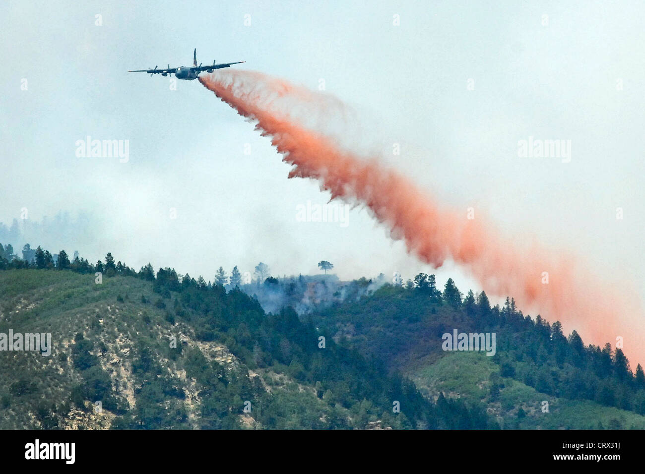A US Air Force MAFFS-equipped C-130 Hercules aircraft drops fire retardant on the Waldo Canyon wild fire as firefighters continued to battle the blaze June 28, 2012 in Colorado Springs, Colorado. Stock Photo