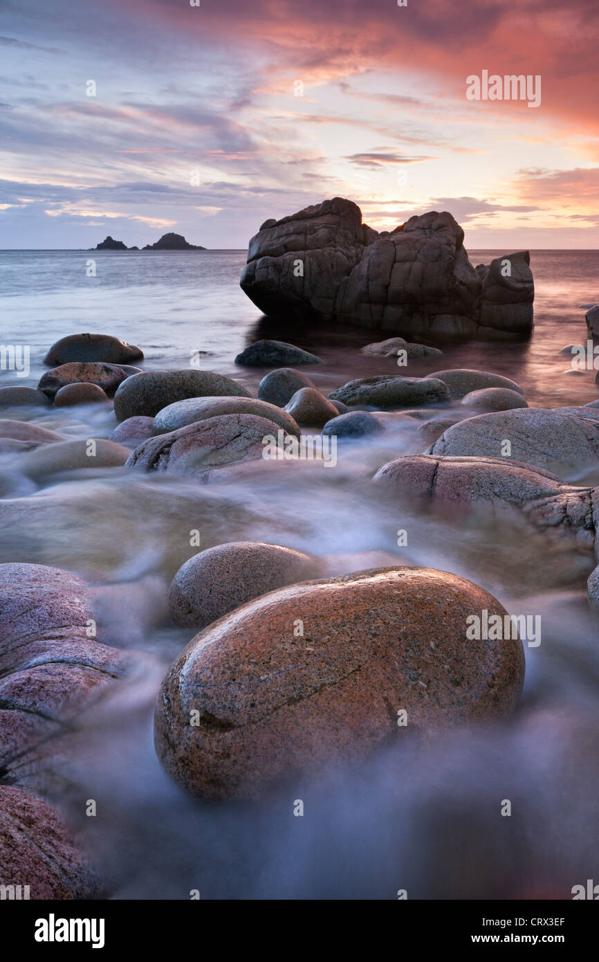 Porth Nanven cove and the Brisons Islands at sunset, Cornwall, England. Spring (April) 2012. Stock Photo