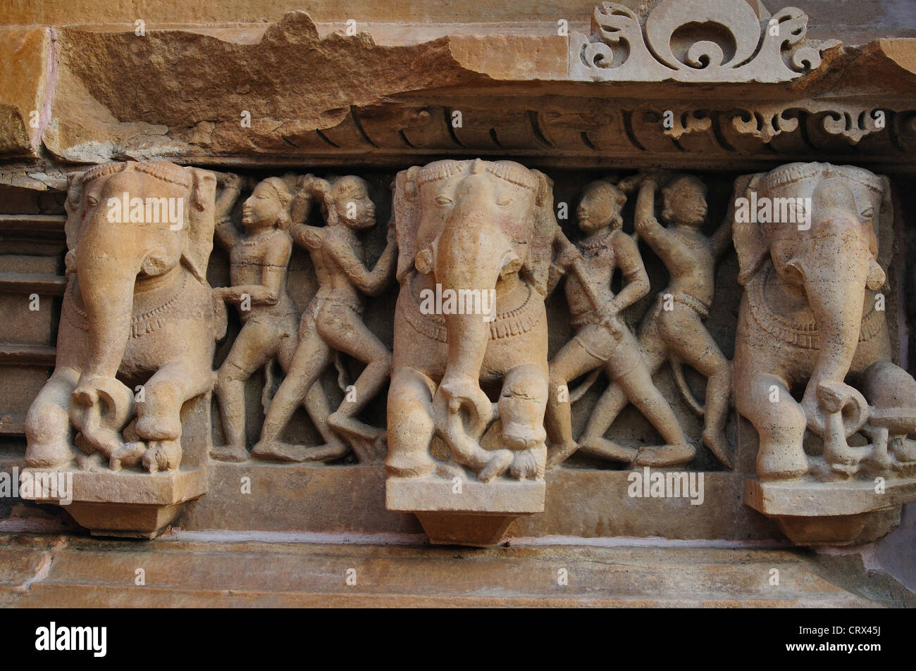 Lakshmana Temple. Elephant sculptures and trainers on base of  platform.  at Khajuraho in India, Asia Stock Photo
