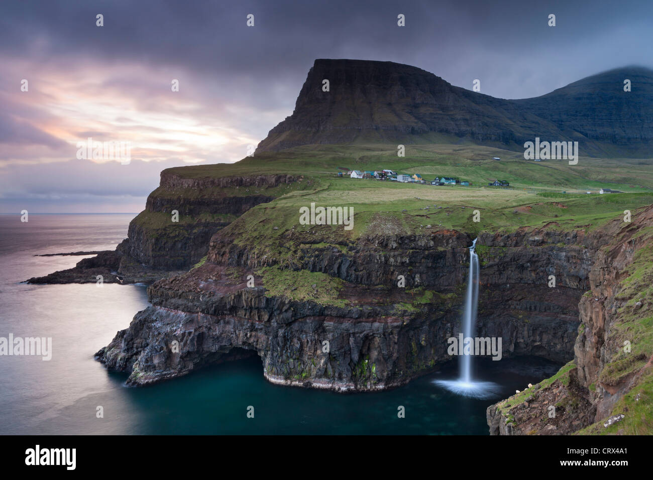 Dramatic coastal scenery at Gasadalur on the island of Vagar, Faroe Islands. Spring (May) 2012. Stock Photo