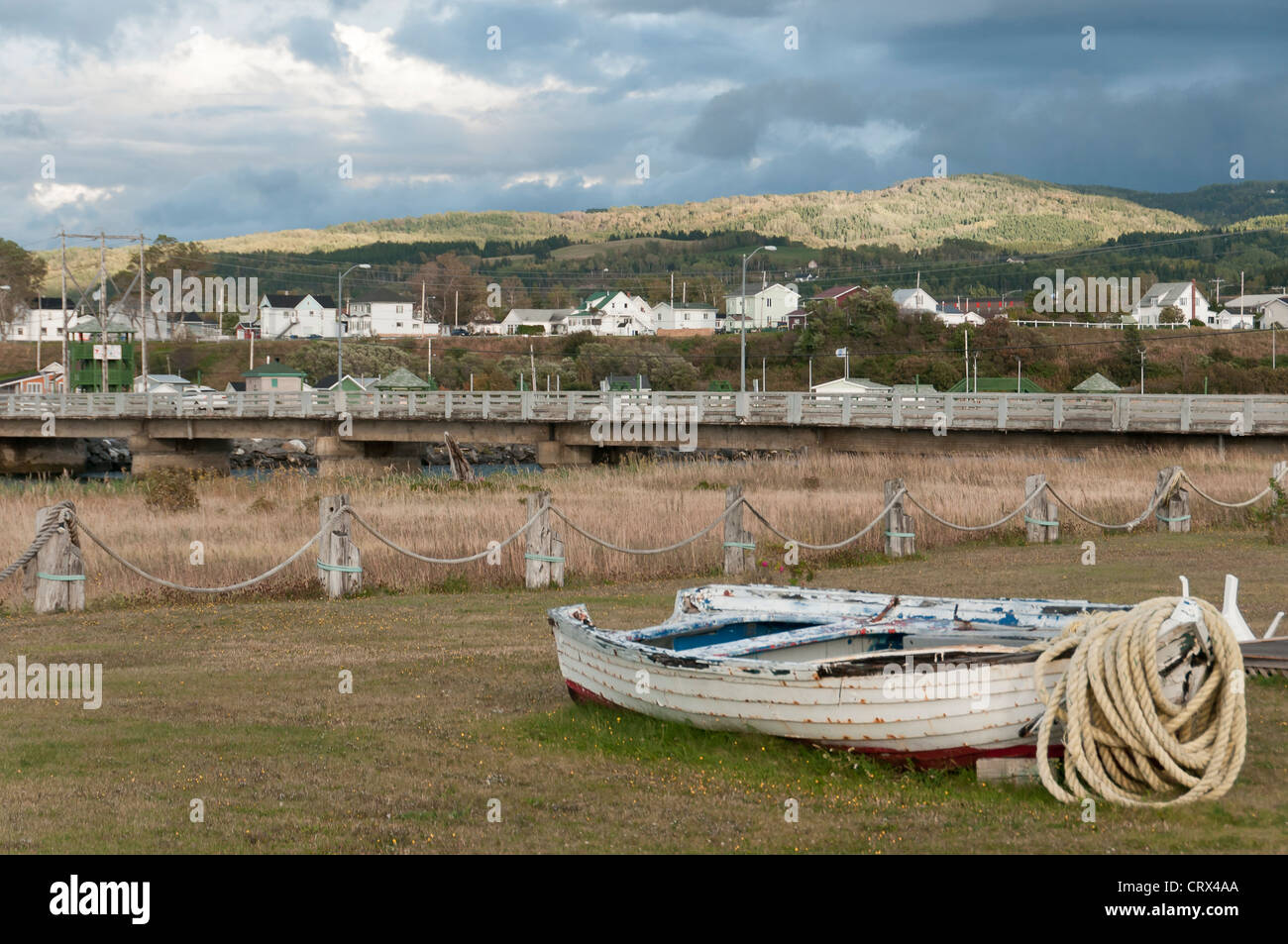 abandoned fishing boat with rope and scenic view of village of Mont SteAnne, Quebec, Canada