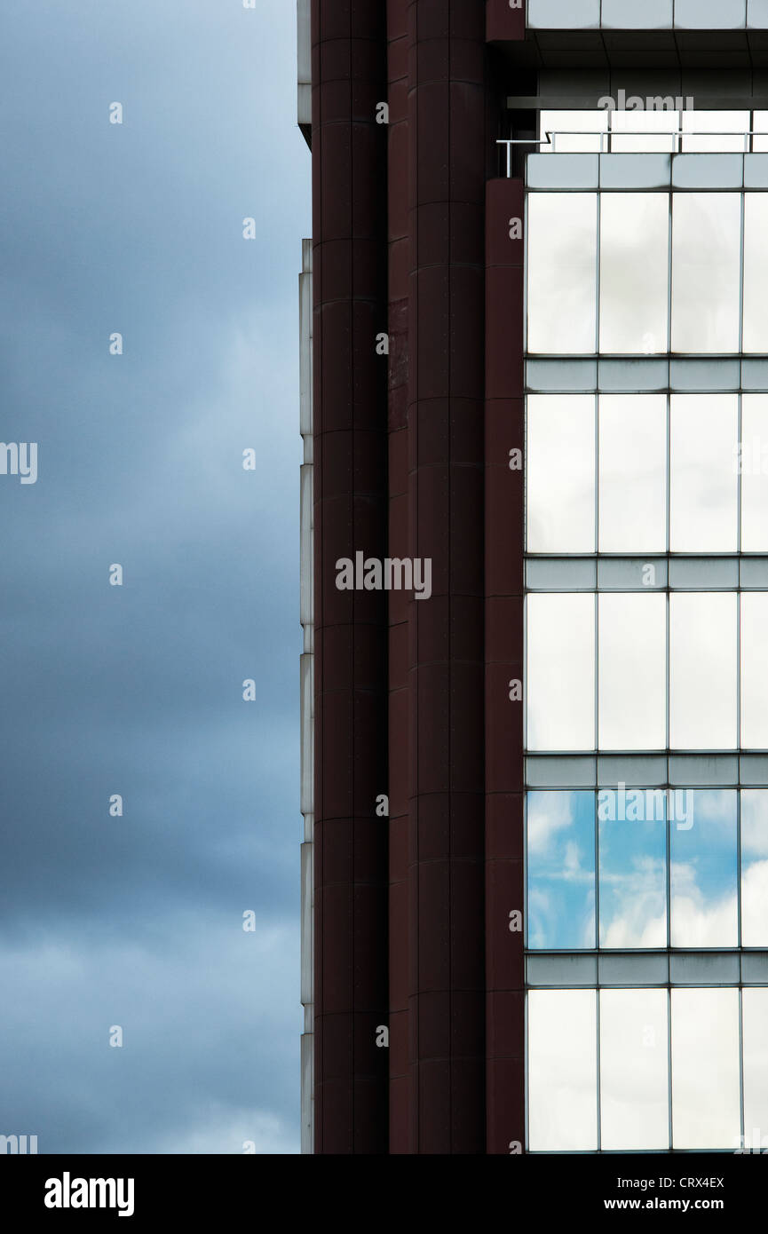 Abstract office building against rain clouds. London, England Stock Photo