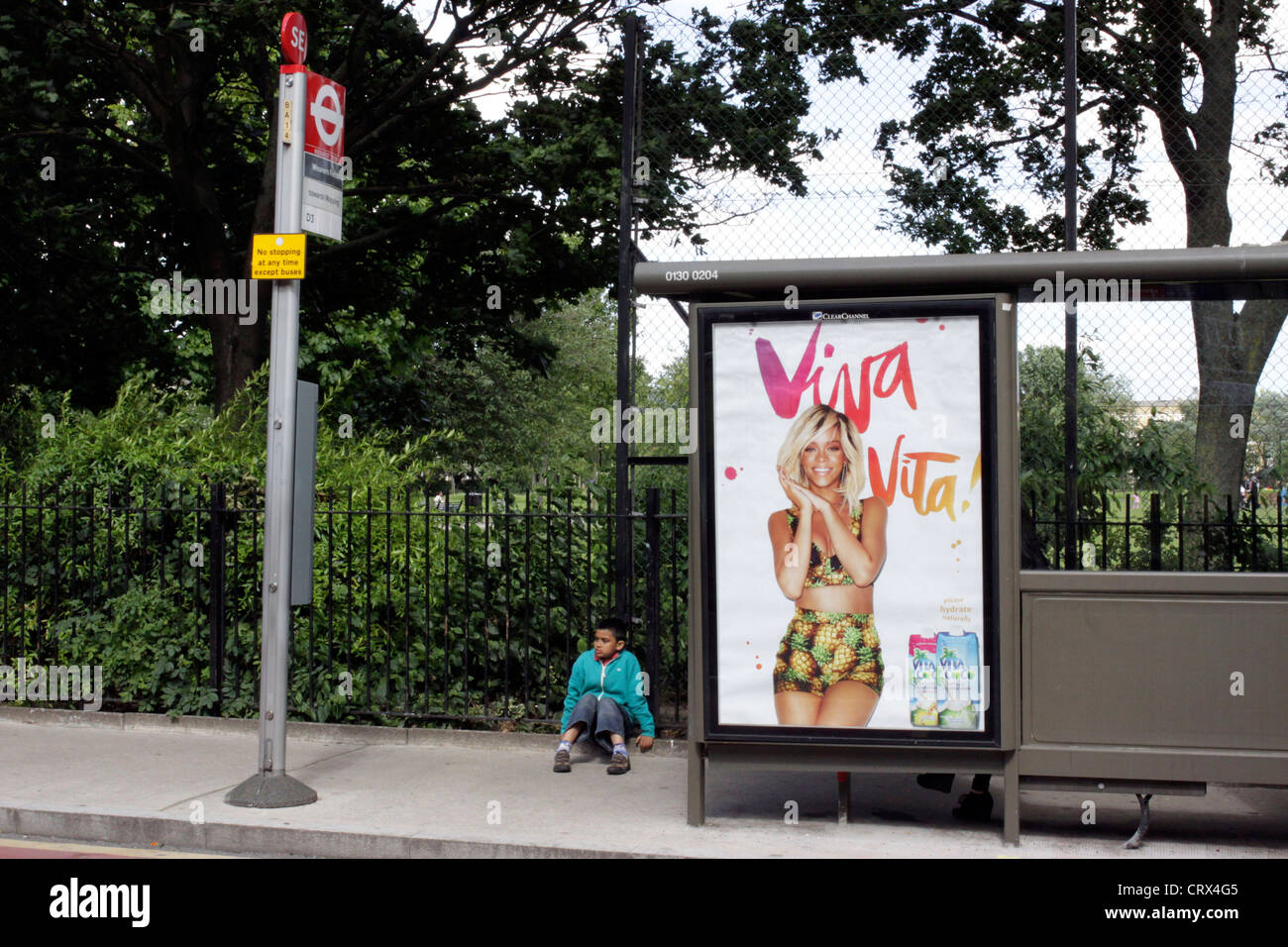 Boy waiting at a bus stop in East London Stock Photo