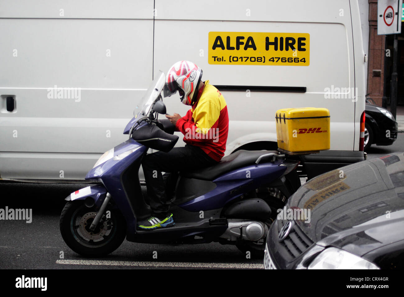Courier rider on his mobile phone Stock Photo - Alamy
