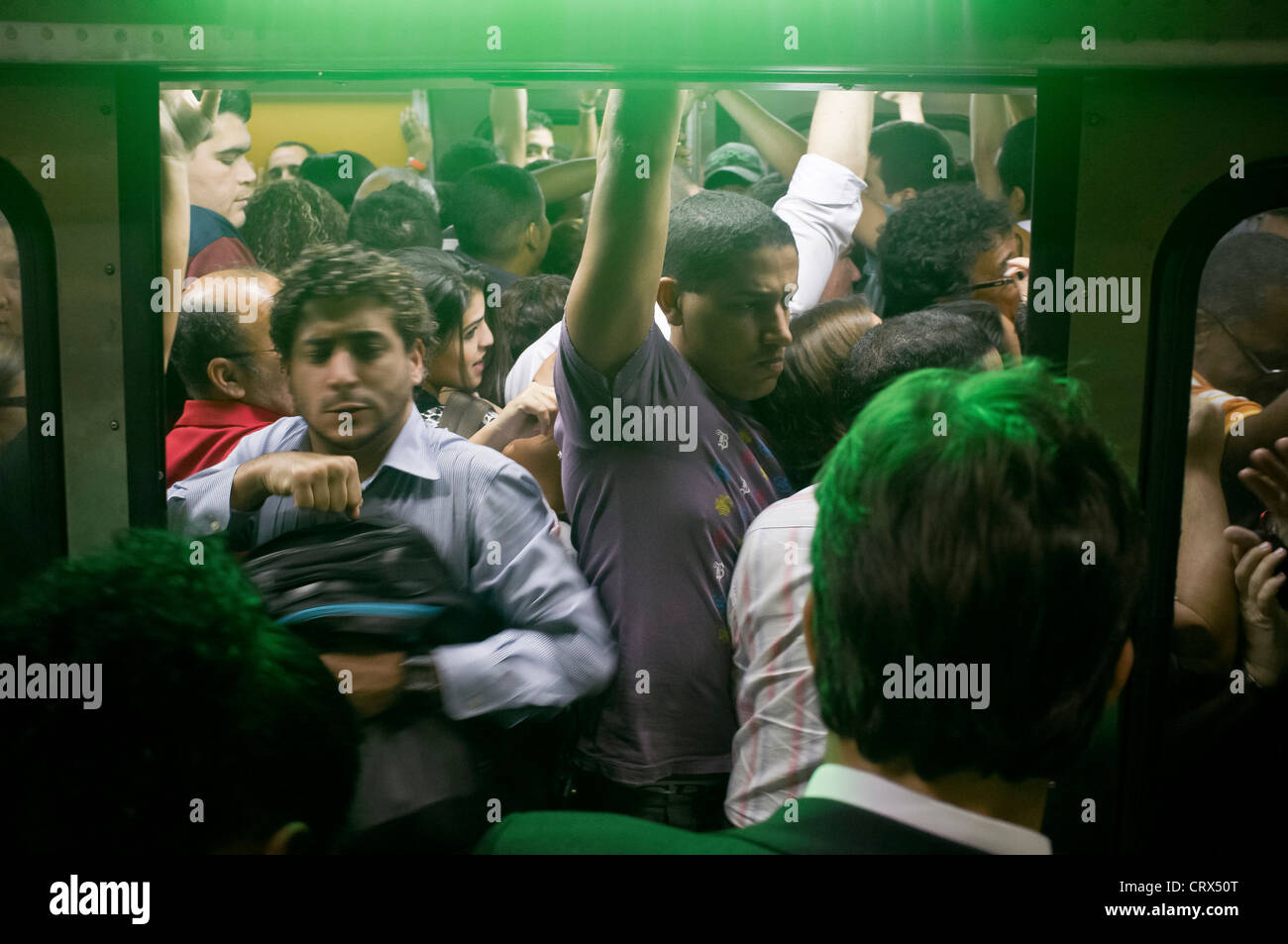 People trying to get into the train at Carioca Station subway in downtown Rio de Janeiro, Brazil. Train door closing Stock Photo