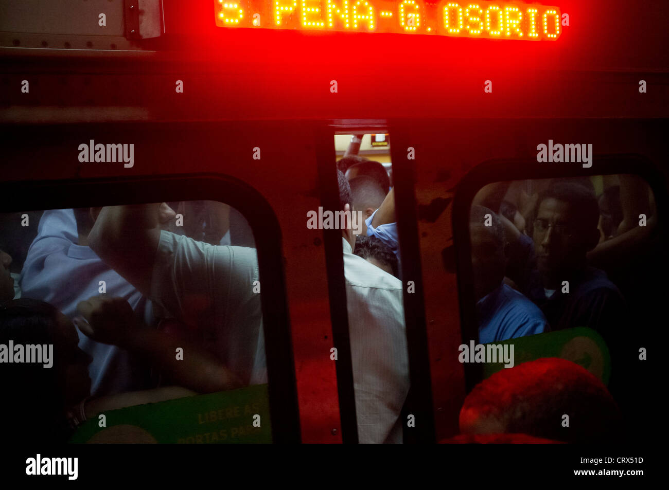 People trying to get into the train at Carioca Station subway in downtown Rio de Janeiro, Brazil Train door closing Stock Photo