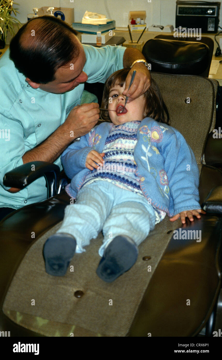 Dentists Surgery Dentist Looks At 4 Year Old Child Teeth Stock Photo