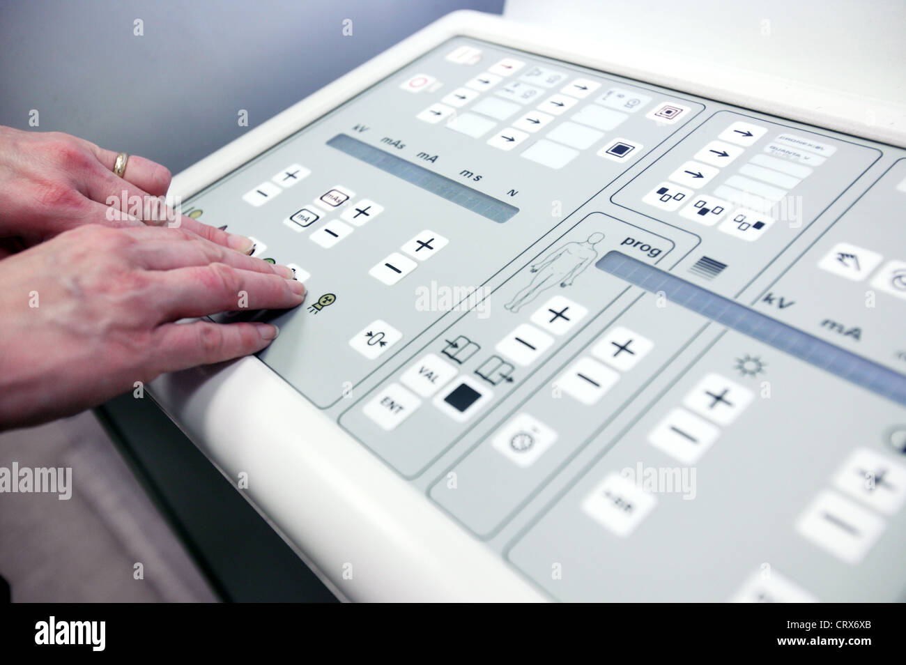 A radiographer's hand preparing to use the x-ray machine control panel. Stock Photo