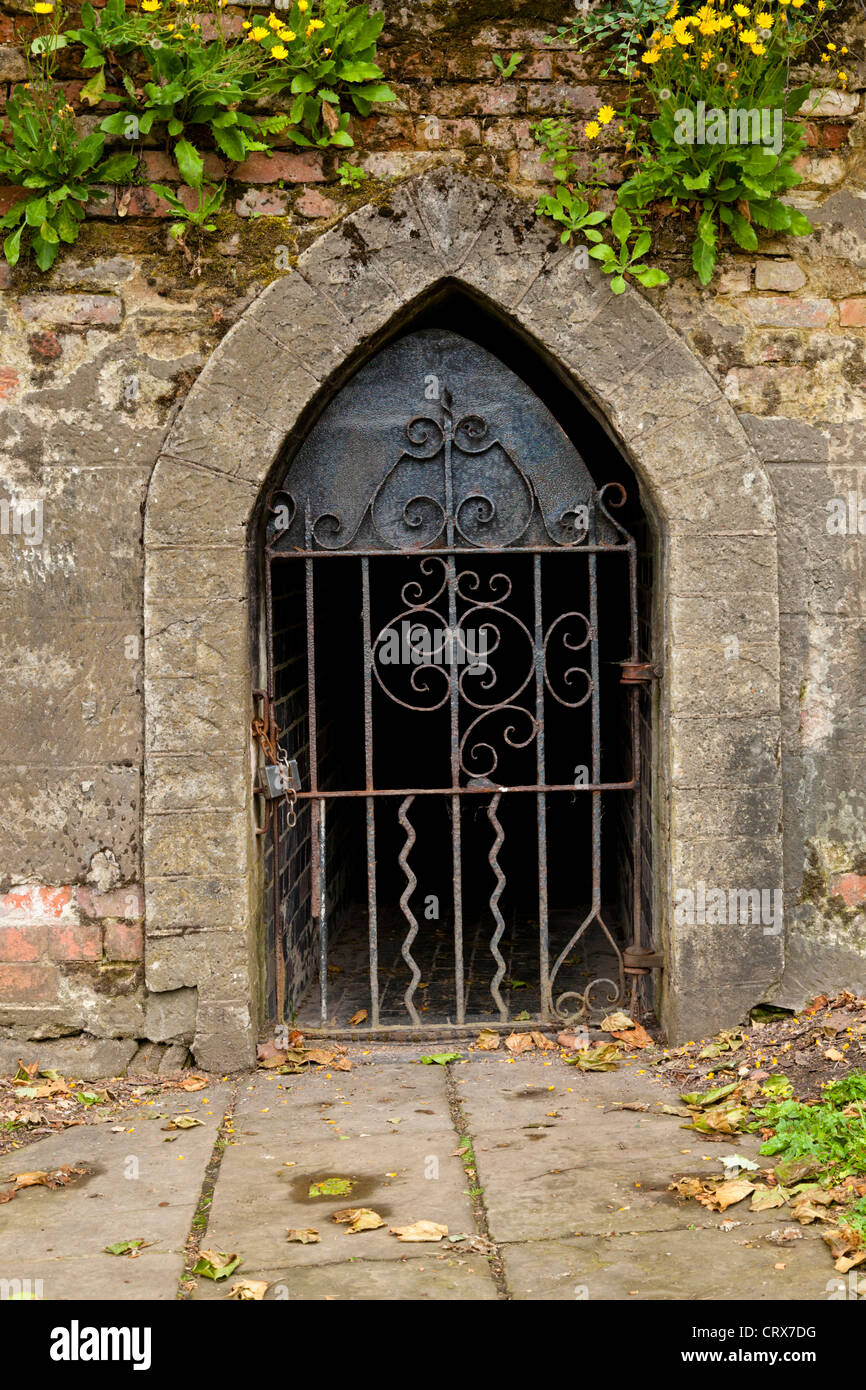 Gated entrance. Gate and door built into the Grade 1 listed outer bailey castle walls leading to a tunnel at Nottingham Castle, England, UK Stock Photo